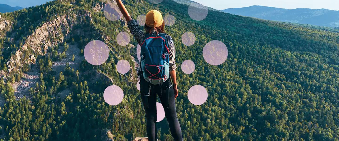 A confident female hiker standing triumphantly on a mountain peak, wearing outdoor adventure gear including a backpack and hat. With one arm raised victoriously, she overlooks a lush, expansive forest valley under clear skies, symbolizing achievement, freedom, and exploration.