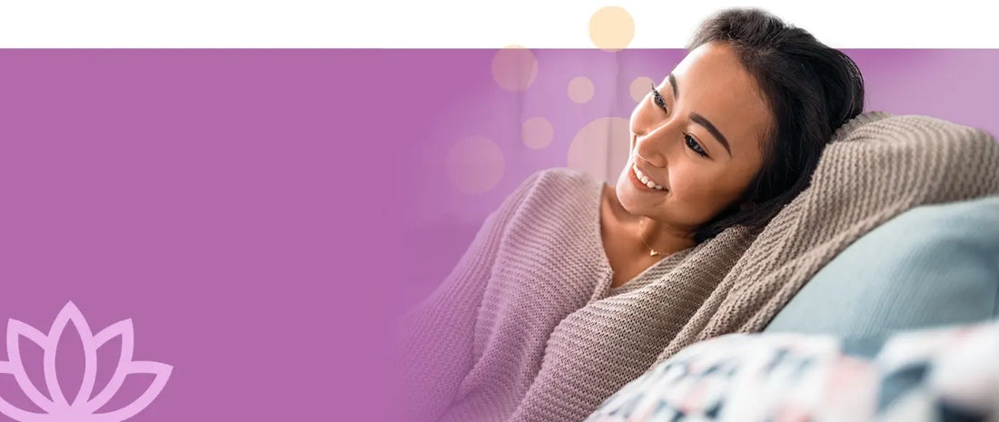 Relaxed and content woman smiling comfortably on a sofa, symbolizing calmness and tranquility, set against a soothing lavender-purple graphic background.