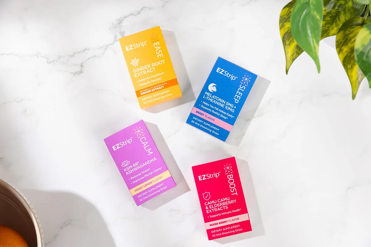 Four EZStrip supplement boxes arranged on a white marble surface, each featuring a different function and color.